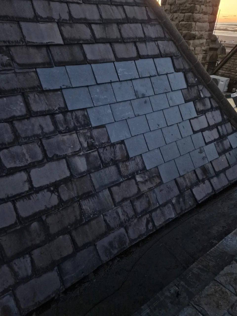 Reinstated slate roof covering the former extractor opening at KFC in Morecambe.