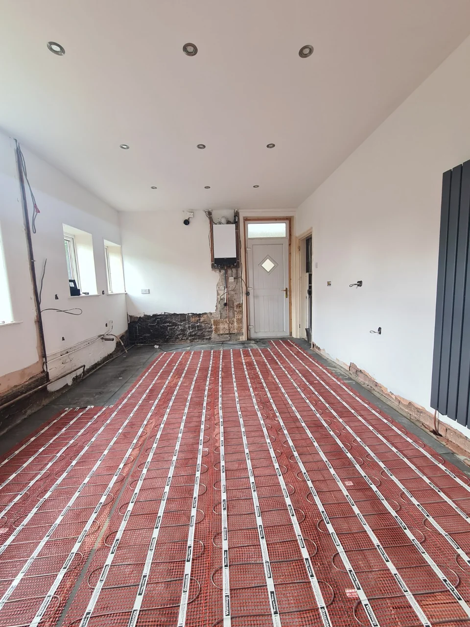 Underfloor heating mats laid across the enlarged Rawtenstall kitchen floor before tiling.