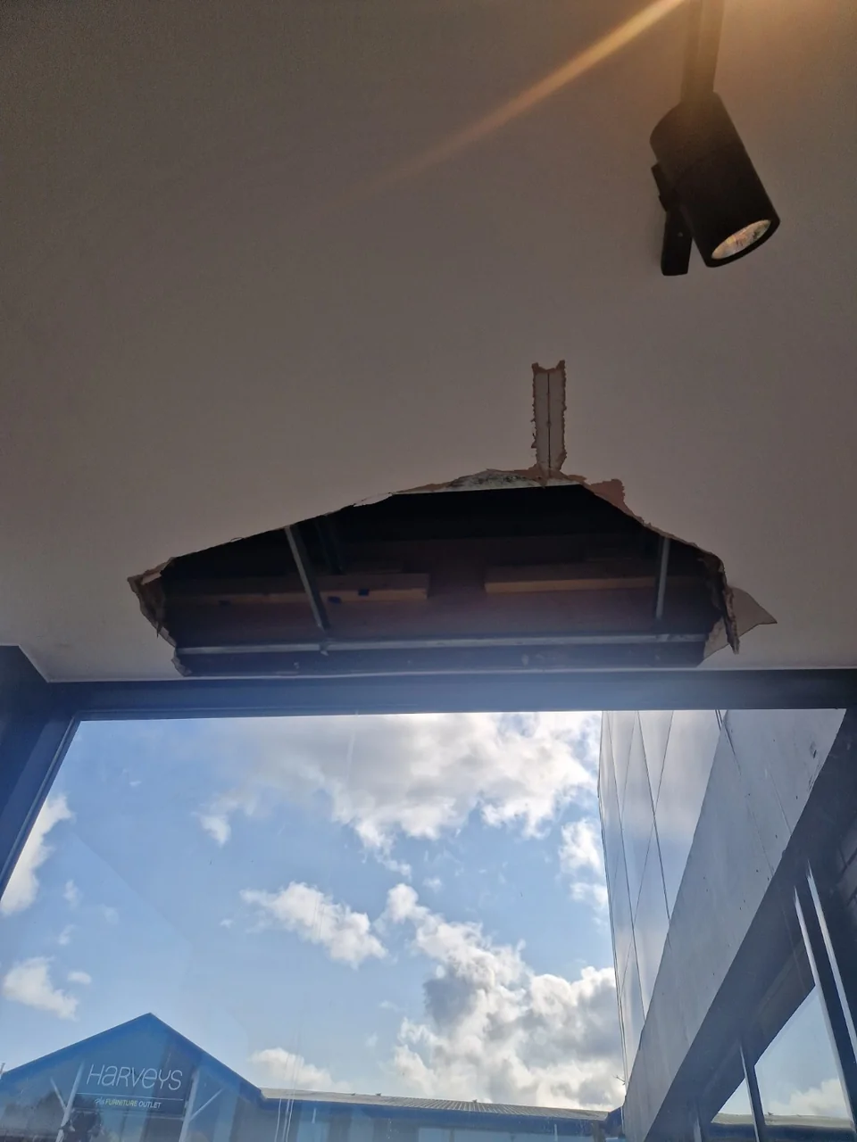 Damaged entrance ceiling after a leak at Tim Hortons in Stockport, showing the open section above the glazing.